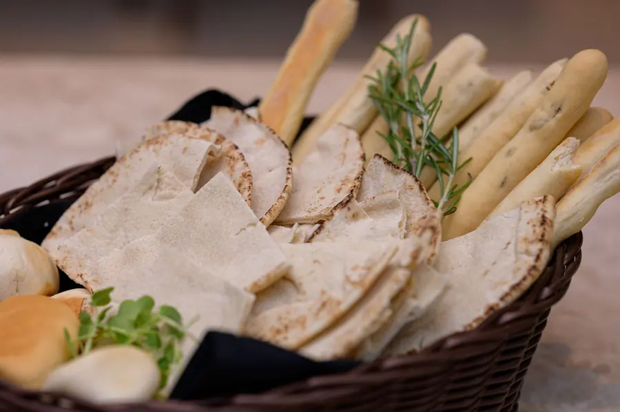 A basket of flatbread served at the table