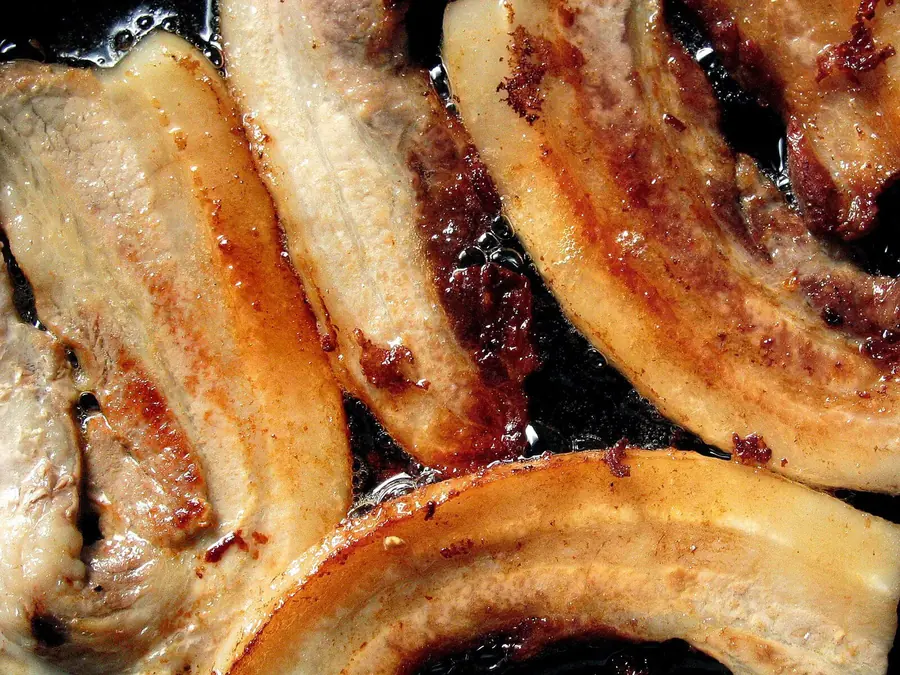 Sliced beef cooking in a pan