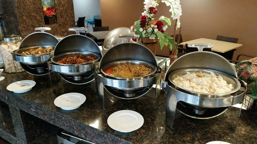 Chafing dishes keeping food warm on a buffet line