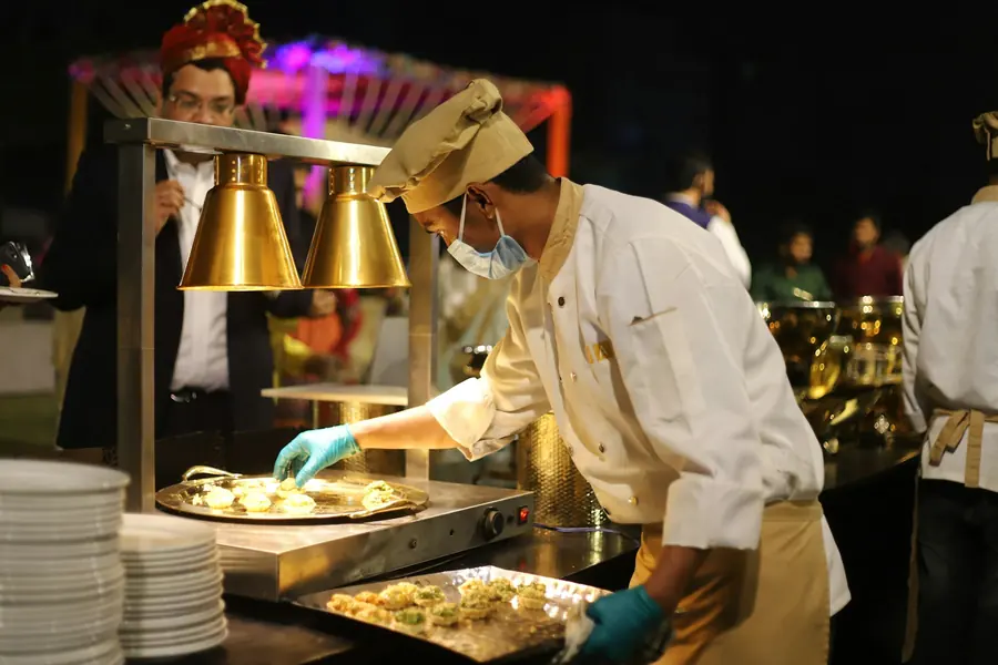 A member of catering staff serving food to guests