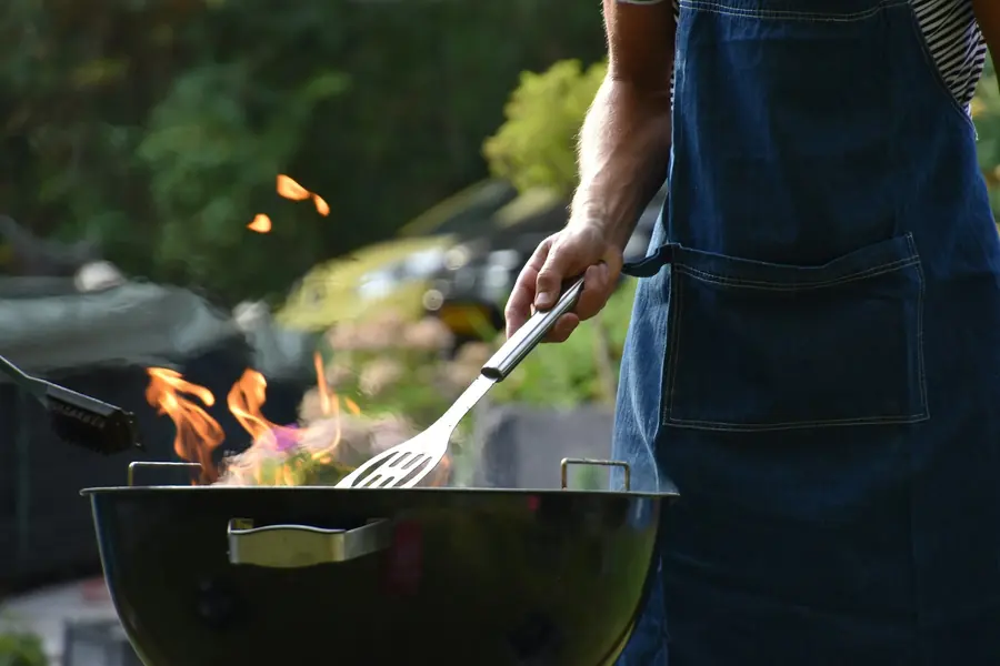 Meat cooking over an open charcoal grill