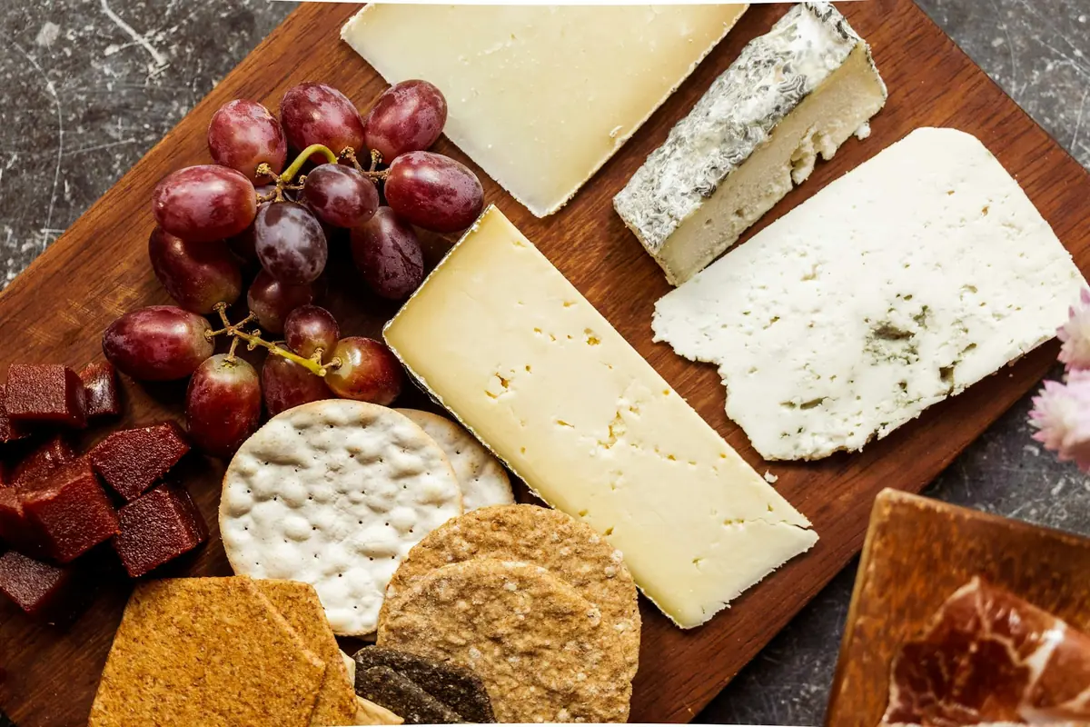 An assortment of cheeses arranged on a board