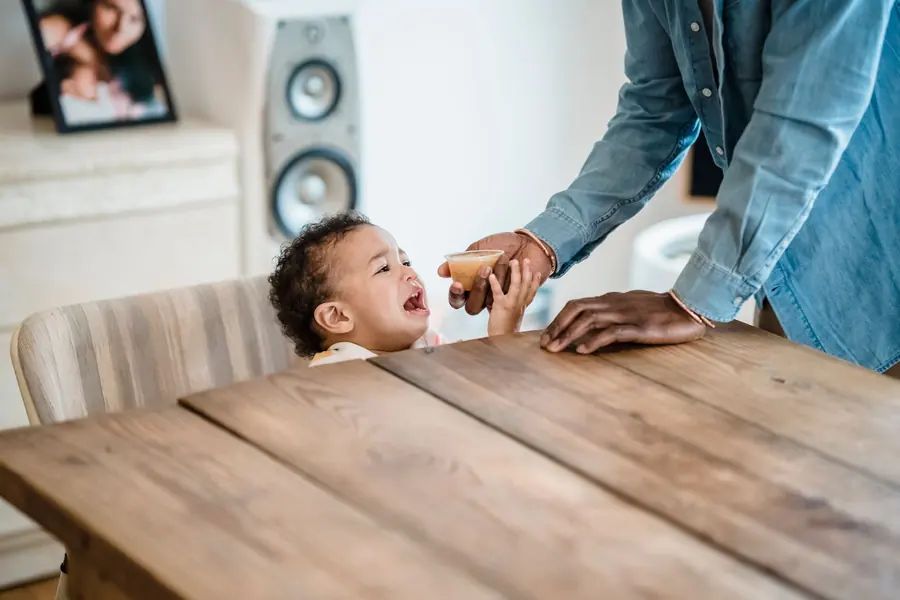 A young child eating at the table