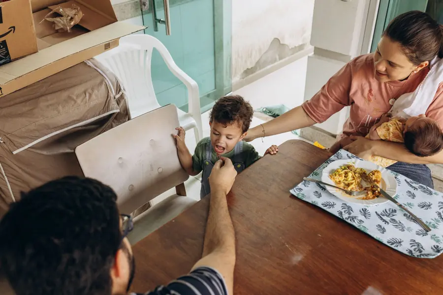 Children sharing food around a table