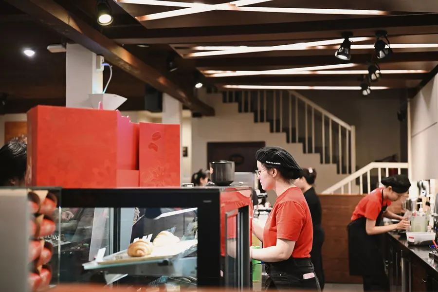 A staff member serving a customer at the counter