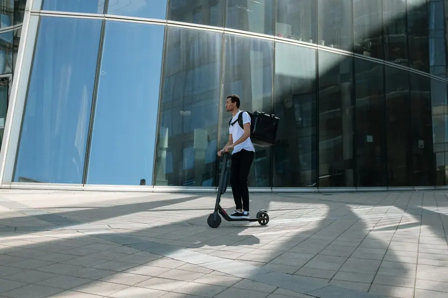 A delivery courier on a scooter