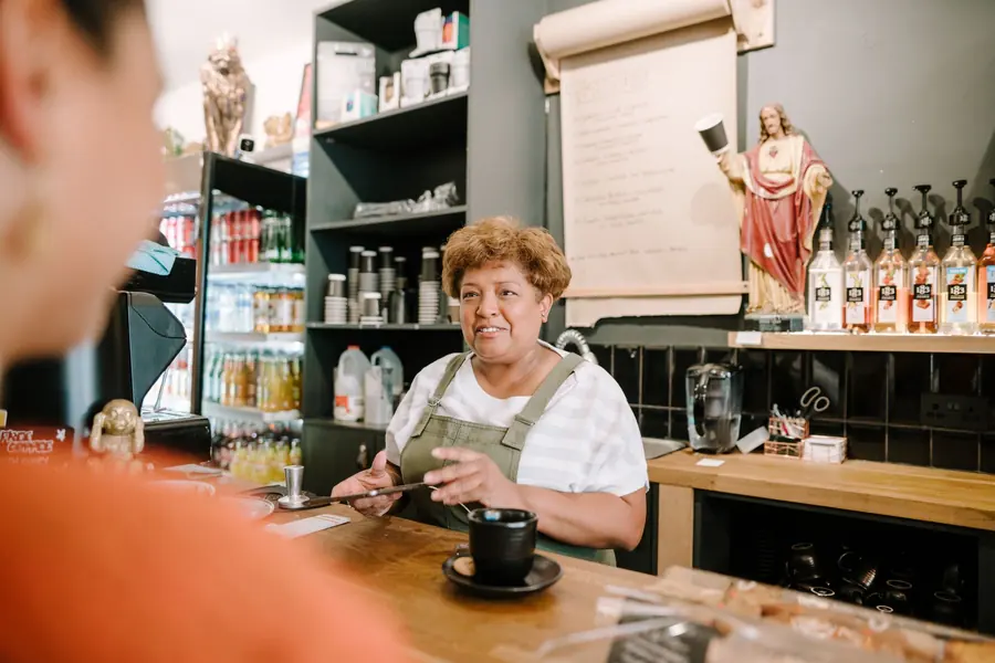 A customer talking to staff at a counter