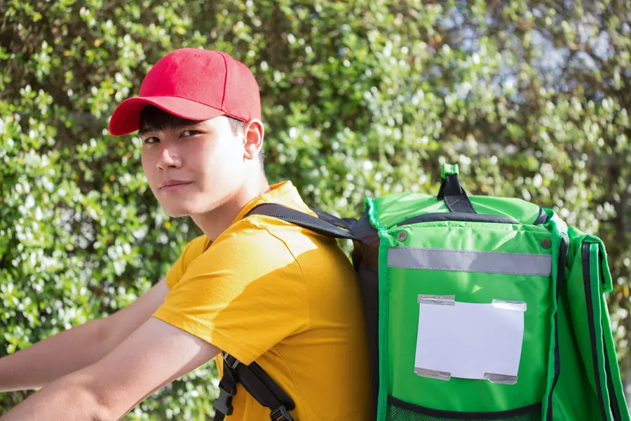 A delivery courier carrying an insulated bag