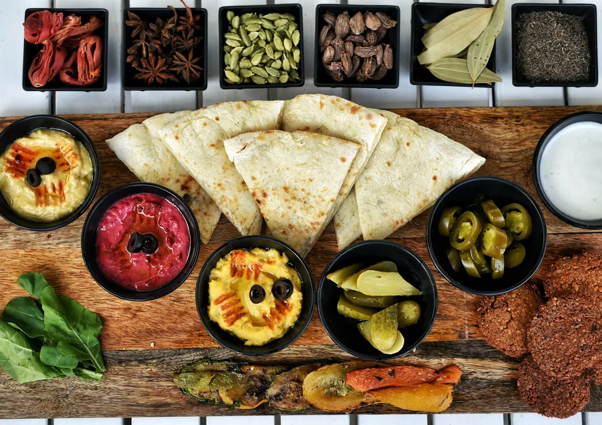 Several dips served in bowls with bread