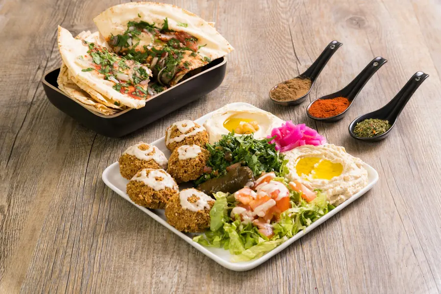 Falafel served with tahini sauce and chopped salad