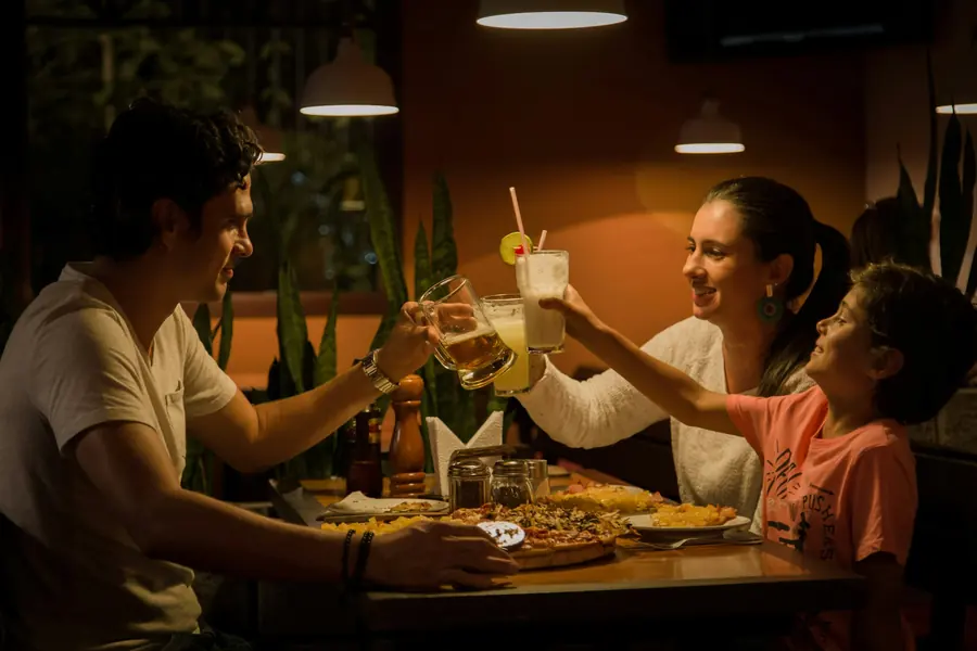 A family sharing an evening meal by lamplight