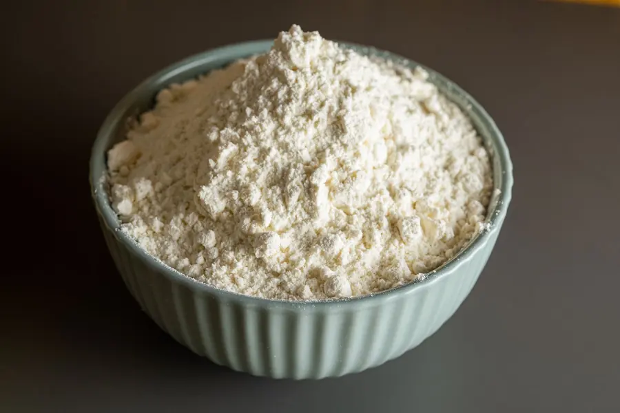 Flour and wheat grains in a bowl