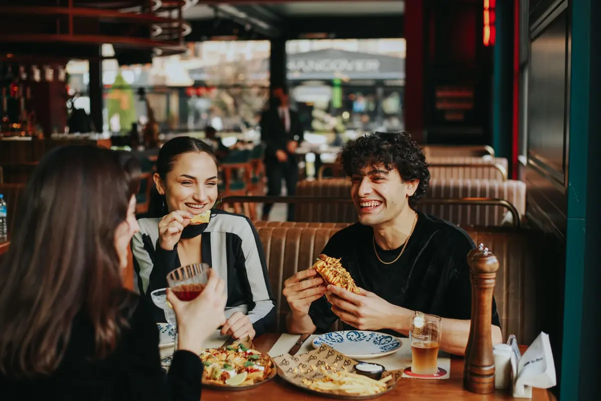 Friends sharing a meal at a restaurant table