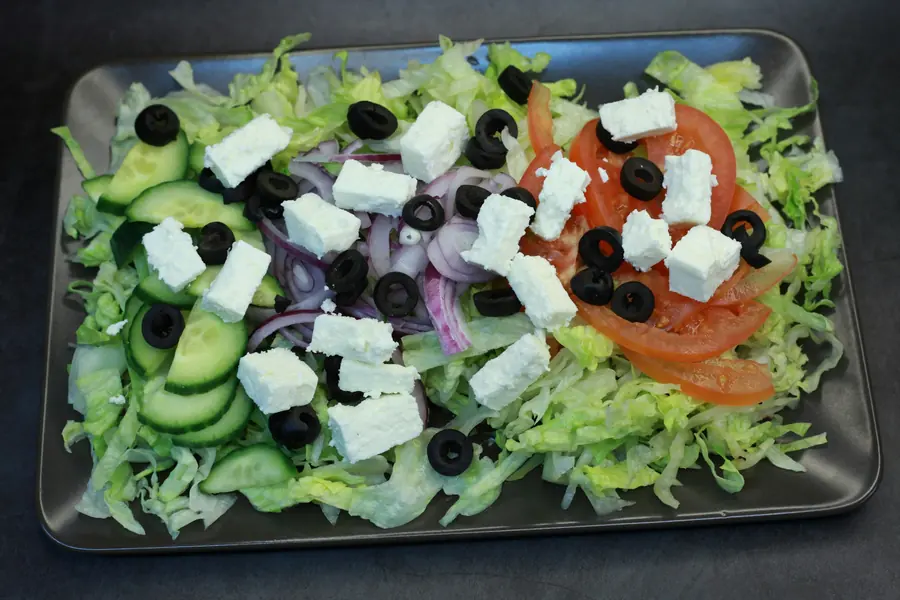 Greek salad with lettuce, tomato, cucumber, olives and feta cheese