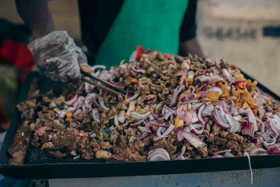 Meat cooking on a griddle at a street stall