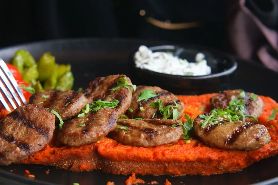 Grilled meat served with sauce on the side