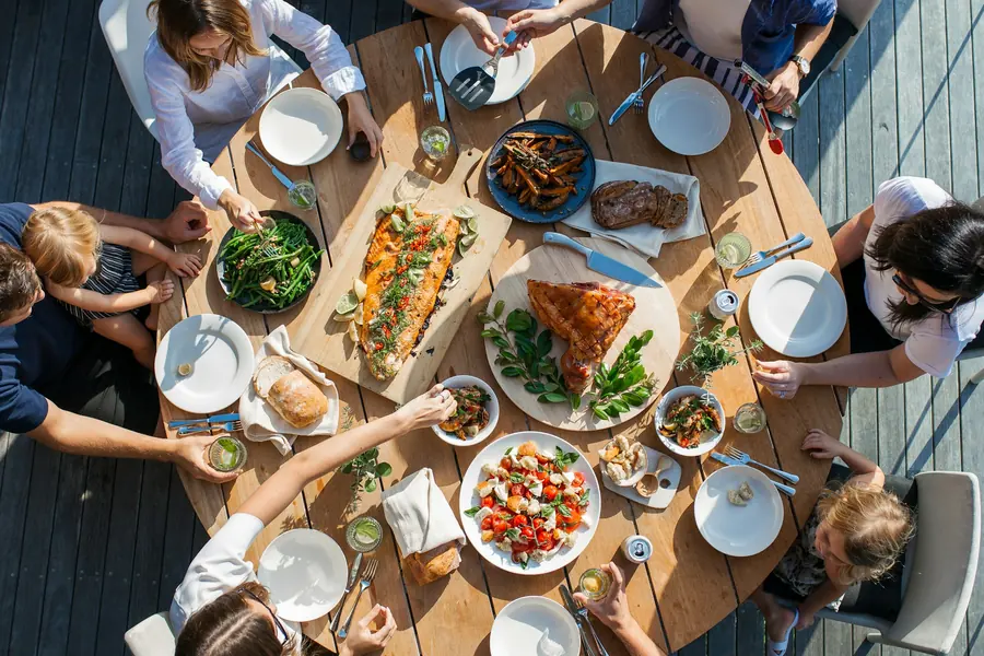 Hands reaching across a table during a shared meal