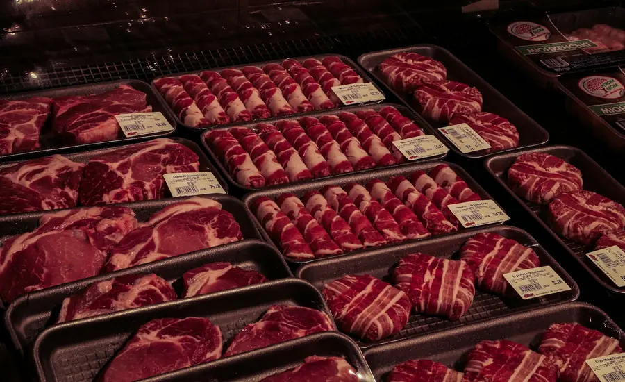 Fresh cuts of meat displayed in a butcher's counter