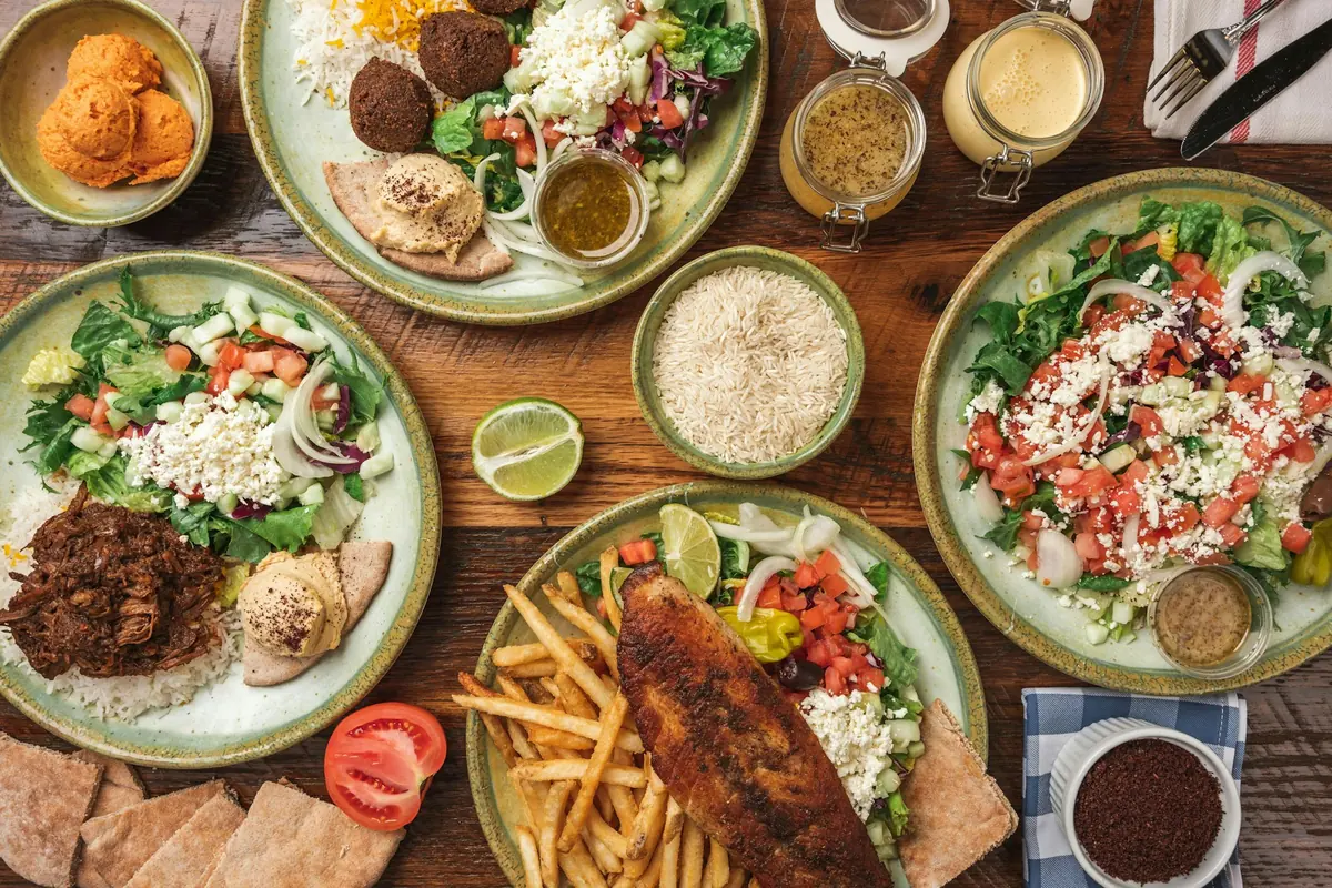 An overhead spread of Middle Eastern dishes on a shared table