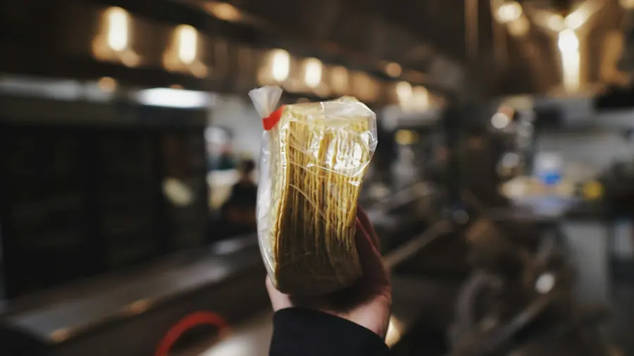 A hand holding a packaged food product
