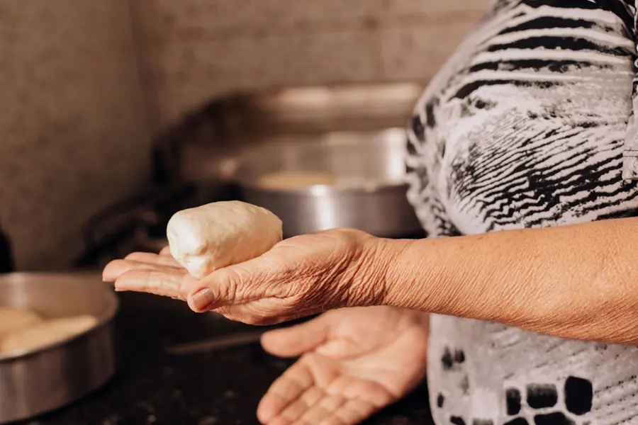 Hands preparing food in a kitchen