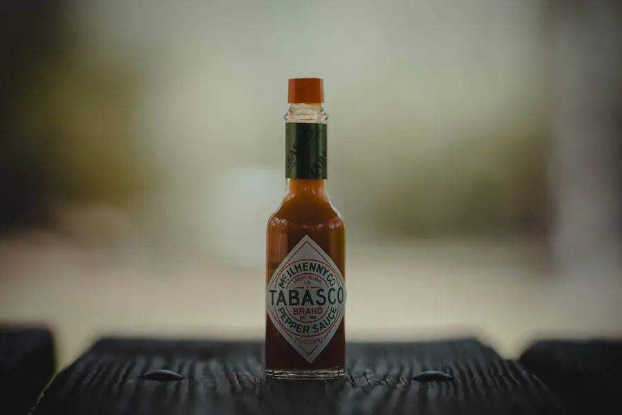 A bottle of hot sauce on a table