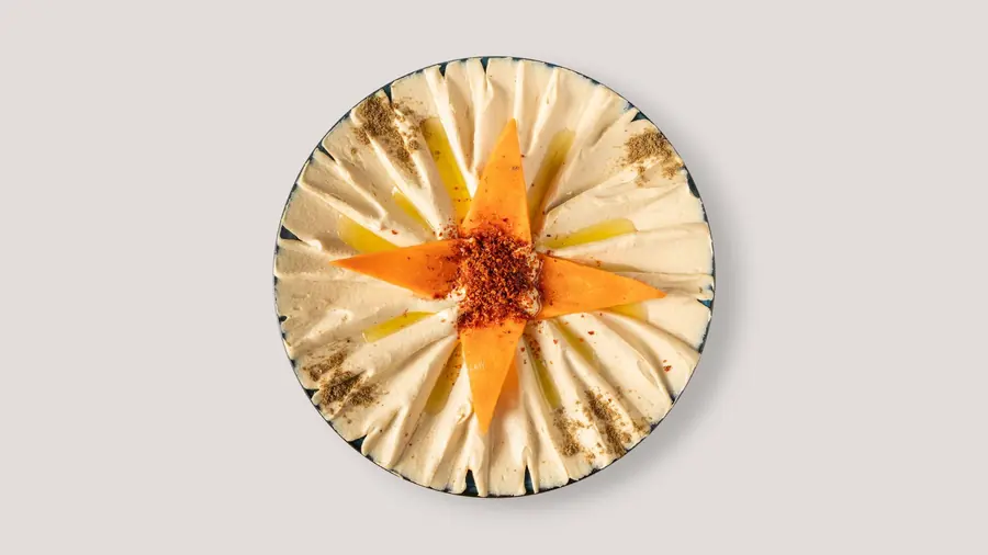 A bowl of hummus finished with olive oil