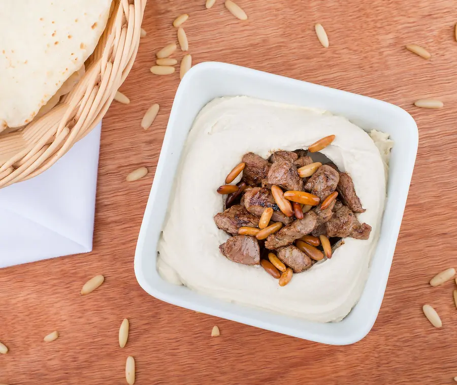 Hummus topped with spiced minced meat and pine nuts