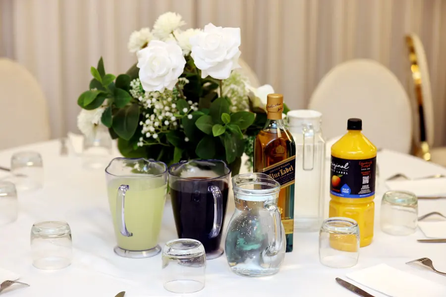 A jug of juice and glasses on a table