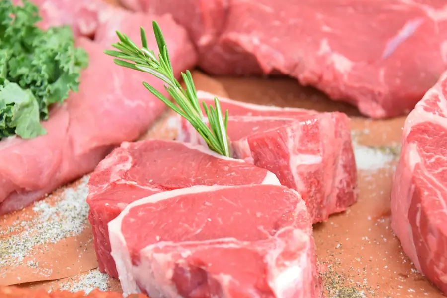 Raw lamb cuts on a butcher's board