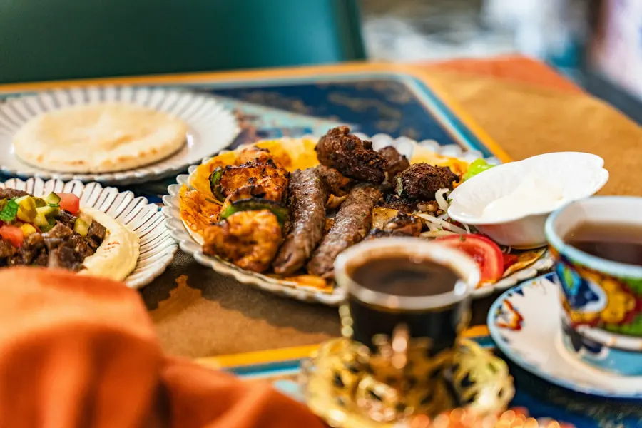 Grilled lamb kofta served with herbs and flatbread