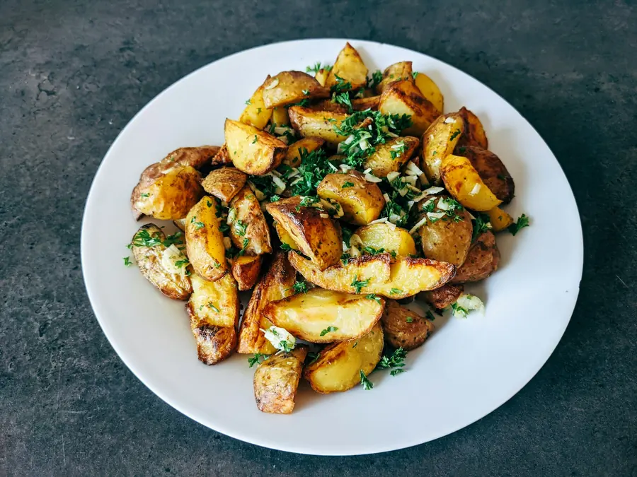 Roasted potatoes with lemon and herbs in a baking dish