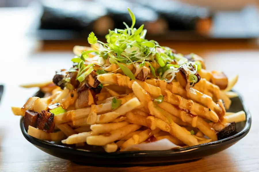 Fries served with toppings and sauce