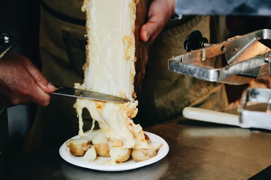 Melted cheese stretching from a slice