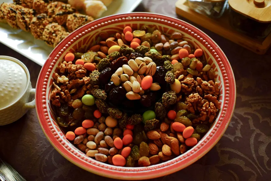 A bowl of mixed nuts including pistachios and walnuts