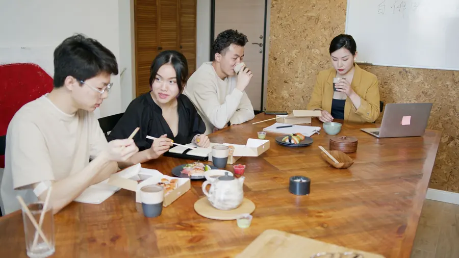 Colleagues serving themselves lunch during a meeting