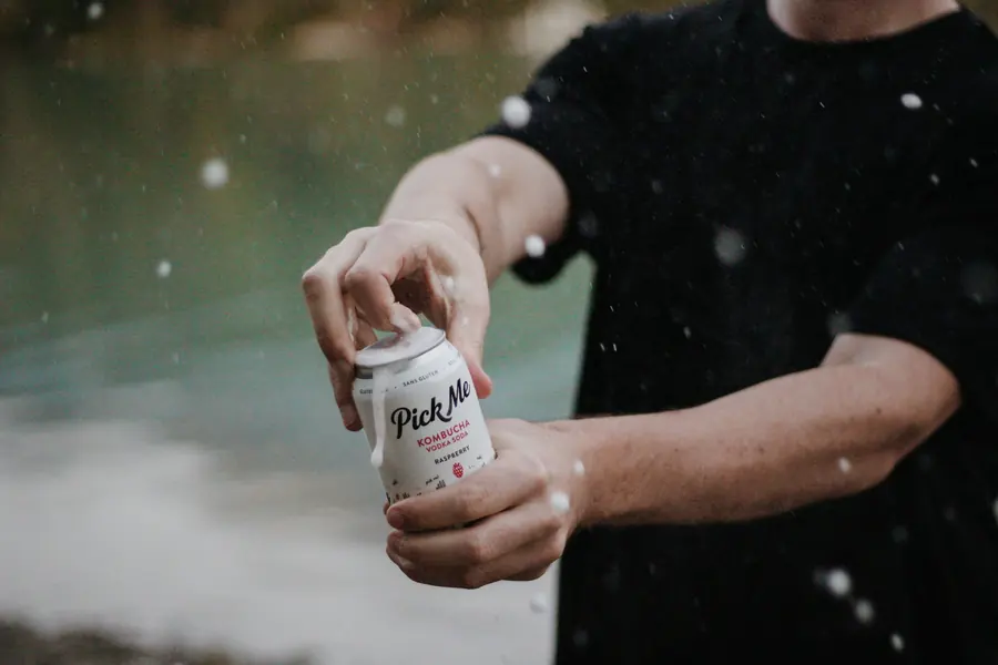 Someone opening a drink can