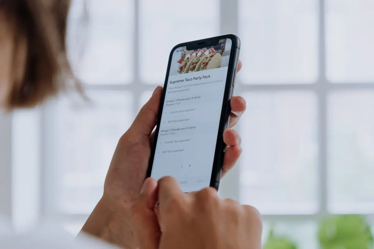 Someone ordering food on a phone