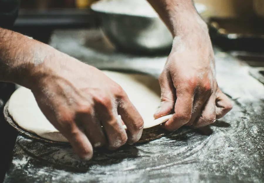 Hands stretching pizza dough on a floured surface