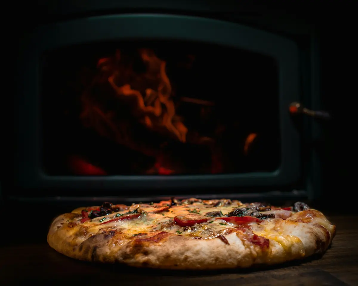 A whole pizza fresh from the oven on a wooden board