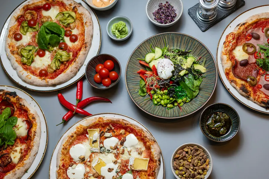 Bowls of prepared pizza toppings ready for assembly