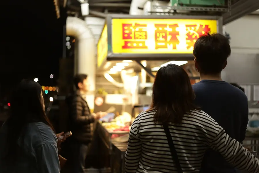 A queue of people at a food stand