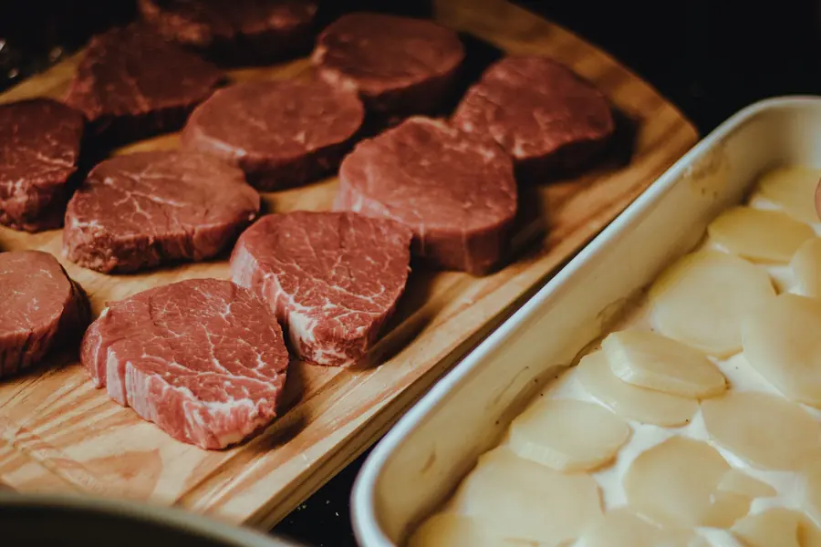 Raw beef steaks on a wooden board