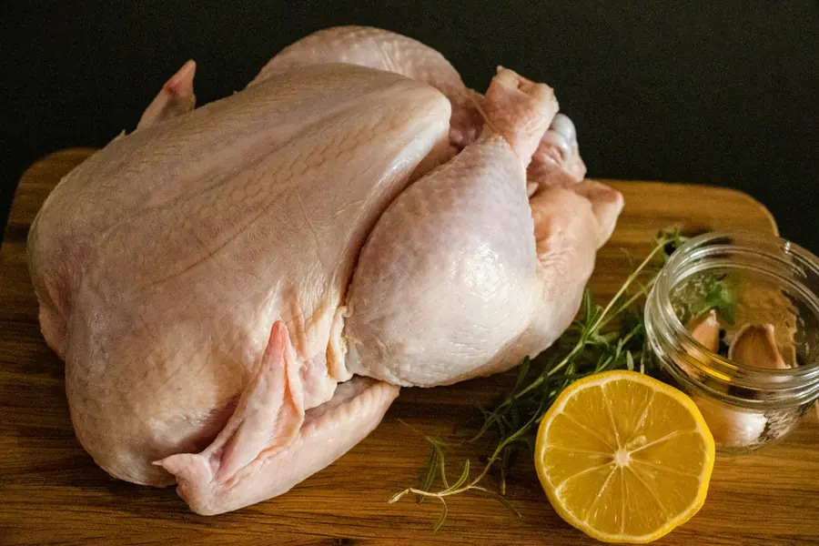 Raw chicken prepared on a tray in a kitchen