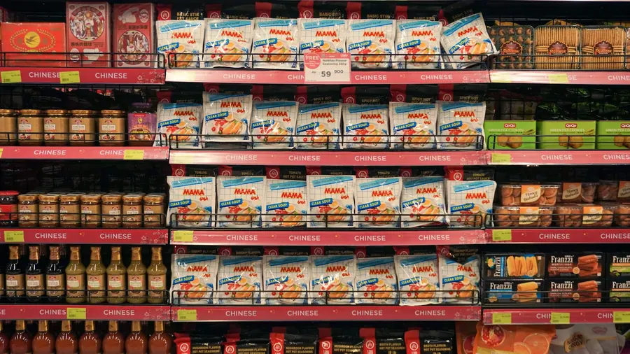 A shopper reading the label on a packaged food product