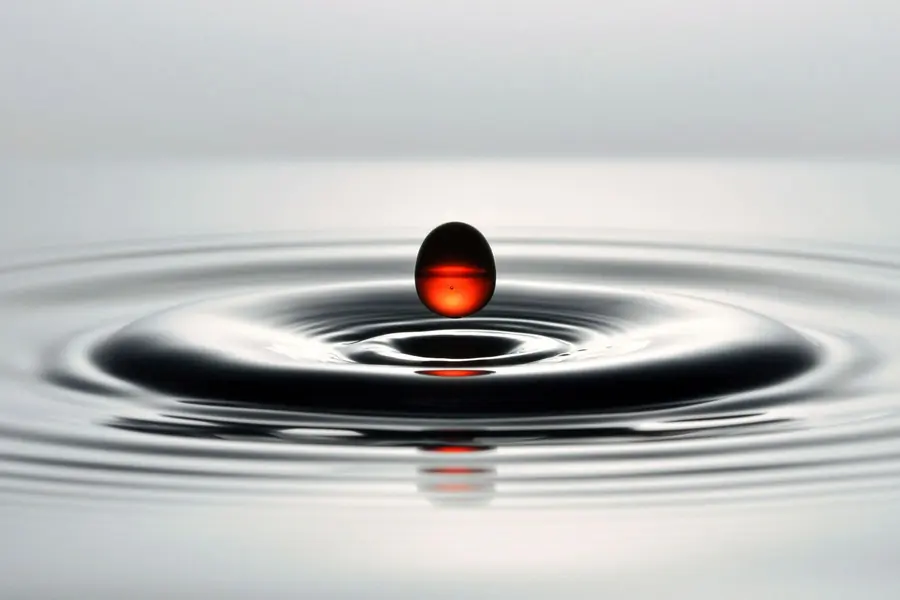 Red food colouring being dropped
