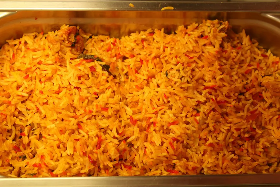 A full tray of seasoned rice prepared for catering