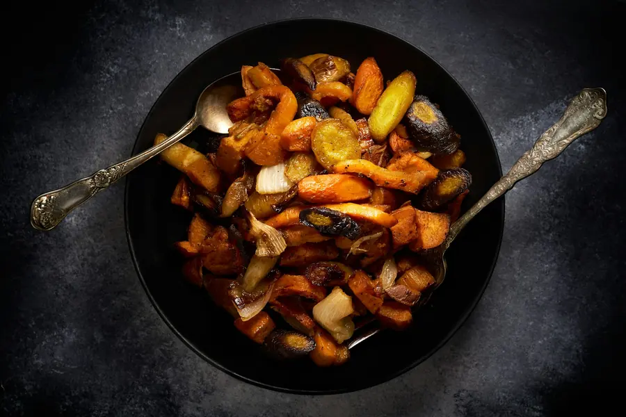 A platter of roasted vegetables with herbs