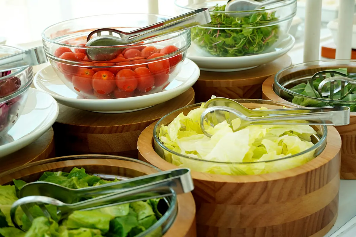 Several fresh salads served in bowls on a table