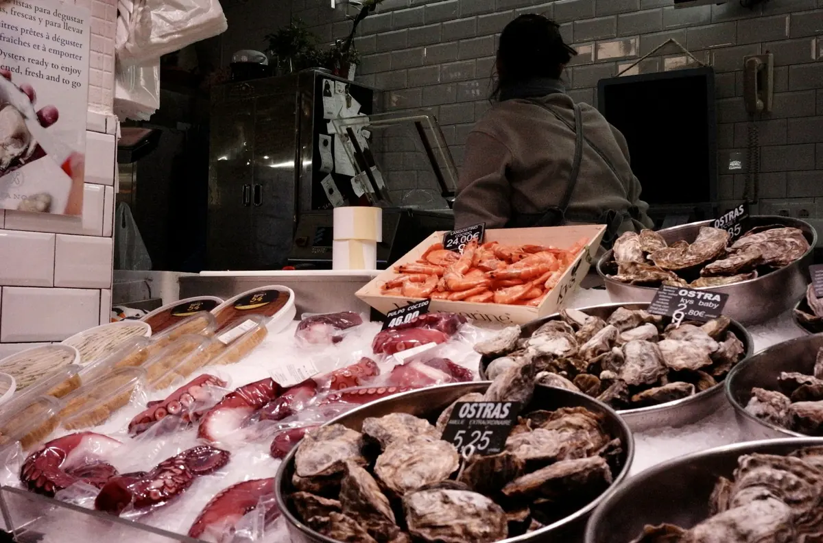 Fresh fish displayed on ice at a market counter